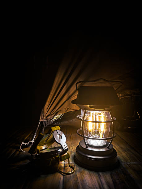 Close up of large battery powered camping lamp with energy saving lamp to stand or hang on white background