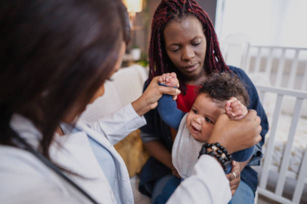 istock Pediatrician examining a baby held by its mother 2194549138