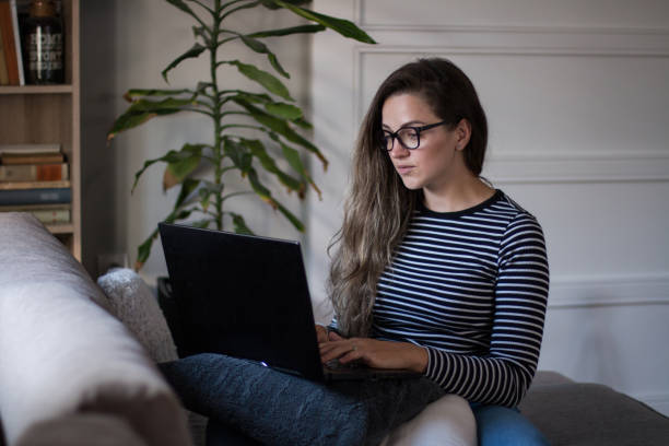 istock Young female freelancer working from home on her laptop computer. 2194549197