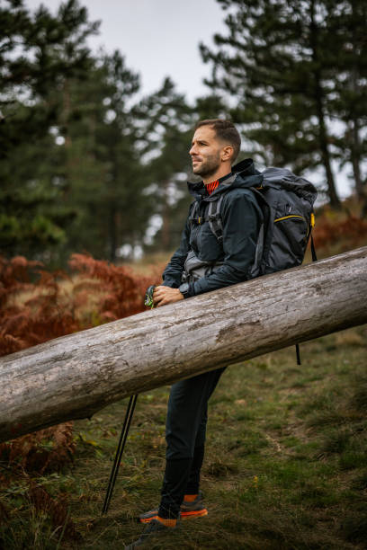 istock Mountaineers taking a break on a log while exploring a tranquil forest landscape during their hiking adventure 2194554460