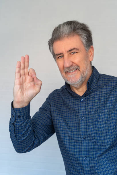 istock Senior white man looking at camera smiling making positive hand gestures 2194558215