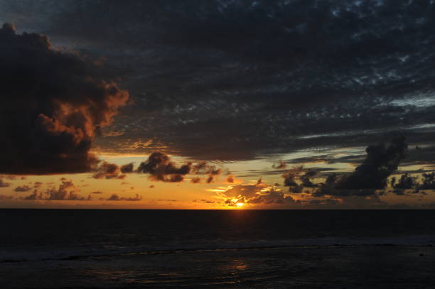 istock Sunset with dramatic clouds with orange sky on a sand beach over the Indian Ocean in Sri Lanka 2194559489