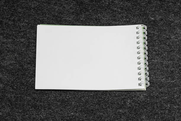 Layout of white book, notebook, notebook, blank notebook cover on gray background. Layout is ready for preview.. a