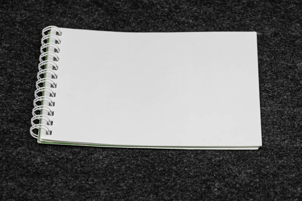 Layout of white book, notebook, notebook, blank notebook cover on gray background. Layout is ready for preview.. a