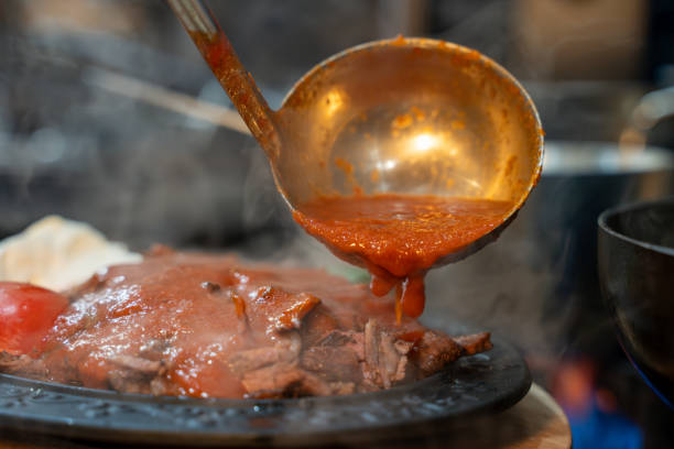 istock Tomato sauce poured over Turkish Bursa Iskender kebab. 2194561088