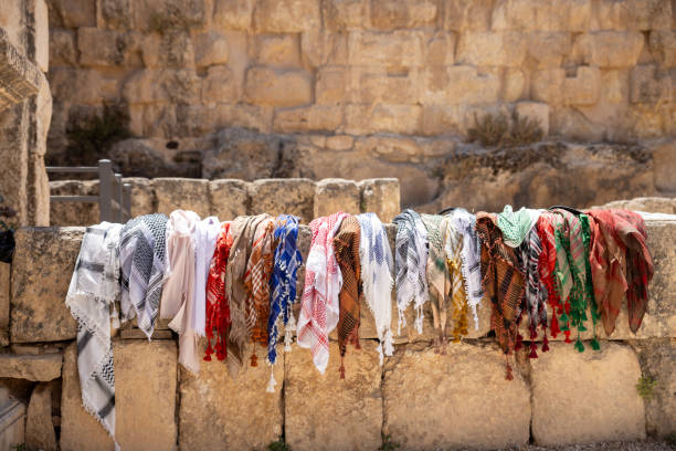 istock Colourful scarves displayed on a stone wall in a historical location during daylight in a serene atmosphere 2194561121