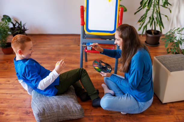 istock Mother and son having fun doing an art project together at home 2194562473