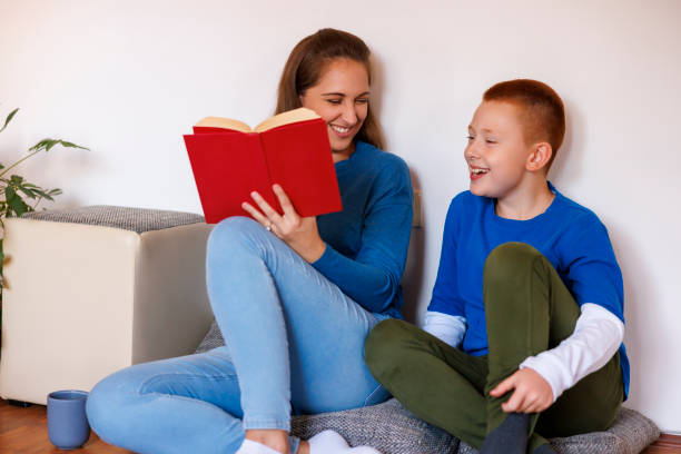 istock Mother and son having fun reading a book together 2194562789