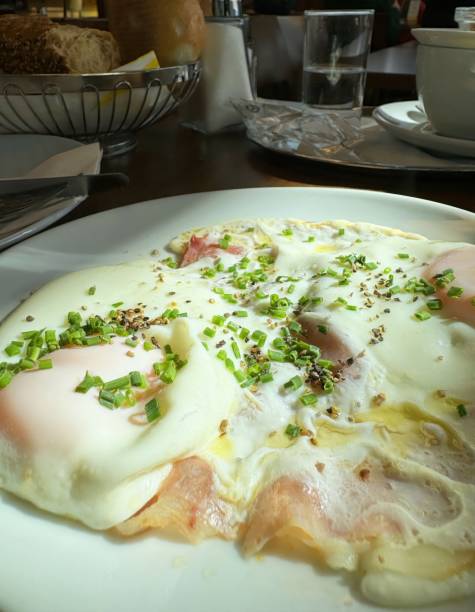 Delicious eggs benedict breakfast with chives and seasoning on a sunny morning, restaurant menu