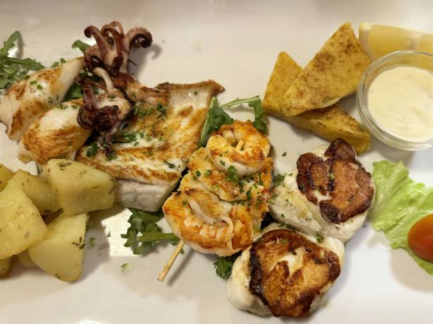 istock Grilled seafood platter with calamari, fish, potatoes, and crispy chips 2194563440
