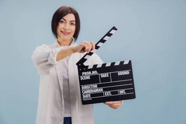 istock Film director using movie clapperboard on light blue background 2194563462