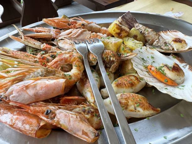 istock Delicious mixed seafood platter with grilled vegetables and herbs 2194563570