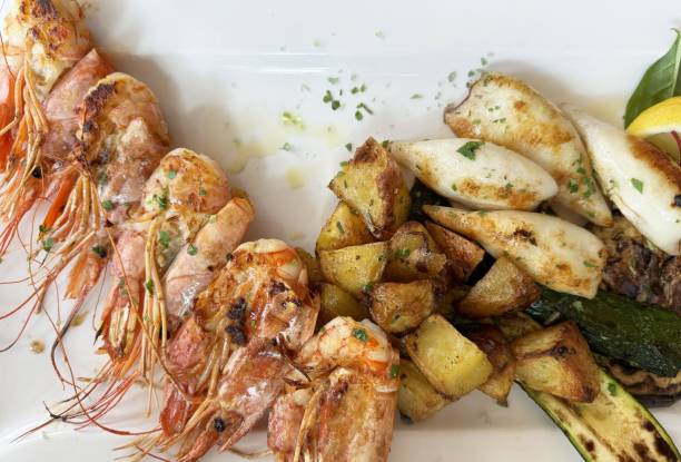 istock Grilled seafood platter with shrimp calamari and roasted vegetables 2194563647