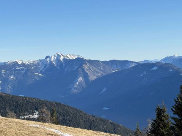 istock Sunny alpine mountain Emberger Alm landscape with clear blue sky and snow-capped peaks 2194564241