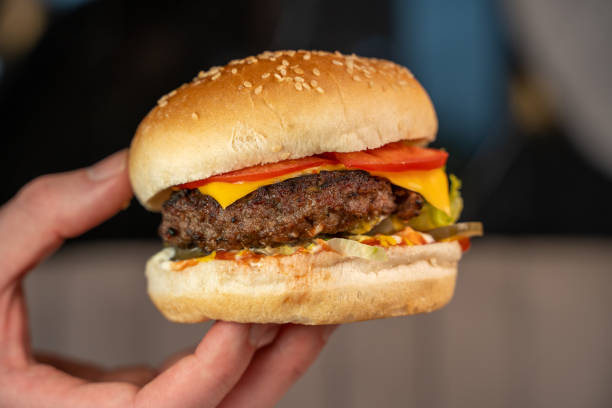 istock Close-up of a juicy cheeseburger in a restaurant 2194565344