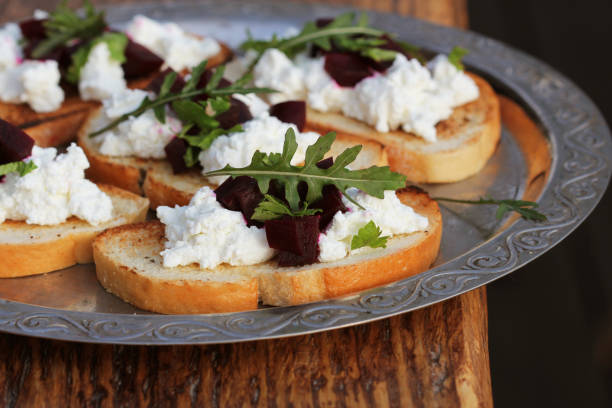istock Sandwiches with feta cheese, beets and arugula on rustic table background. Healthy breakfast or snack 2194565961