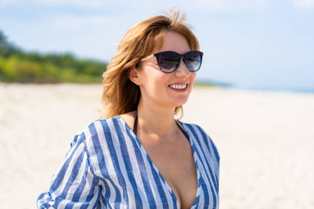 istock Mature woman enjoying vacation at the beach 2194566421