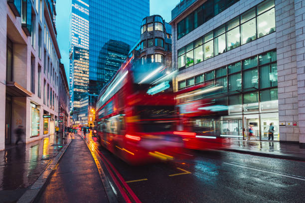 istock Red double-decker bus speeding through illuminated london streets at dusk 2194566514