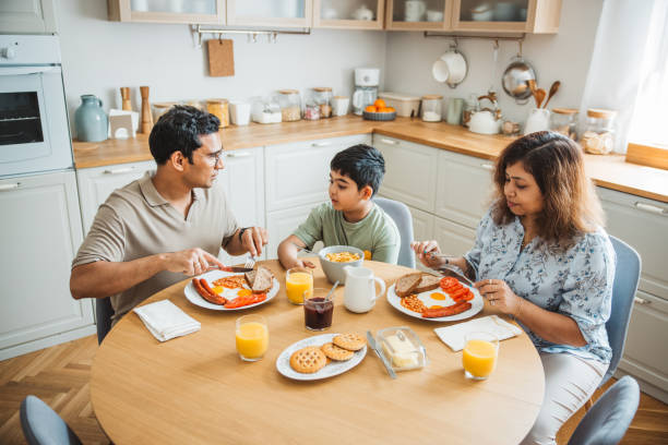 istock Family of three having breakfast together in the kitchen. 2194566954