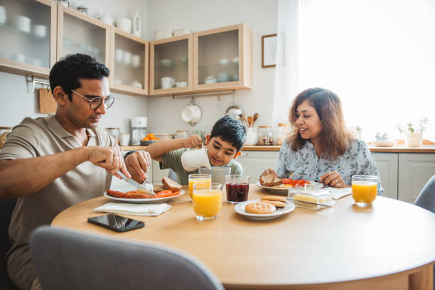 istock Family of three having breakfast together in the kitchen. 2194566955