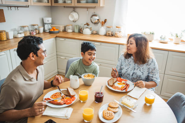istock Family of three having breakfast together in the kitchen. 2194566970