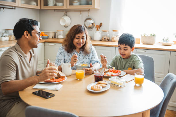 istock Family of three having breakfast together in the kitchen. 2194566972