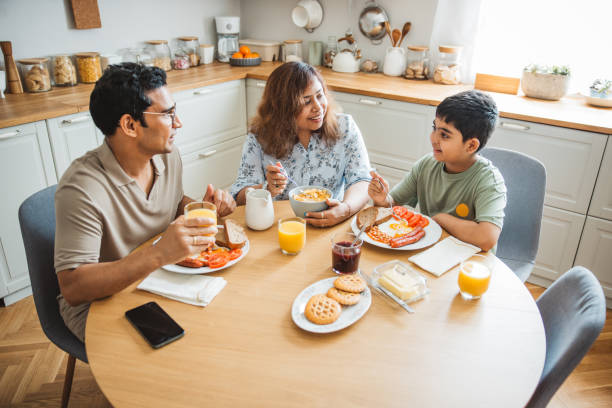 istock Family of three having breakfast together in the kitchen. 2194566978