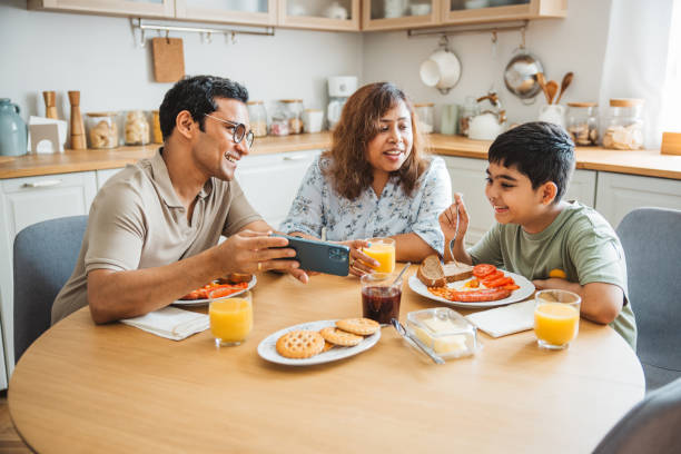 istock Family of three having breakfast together in the kitchen. 2194567020