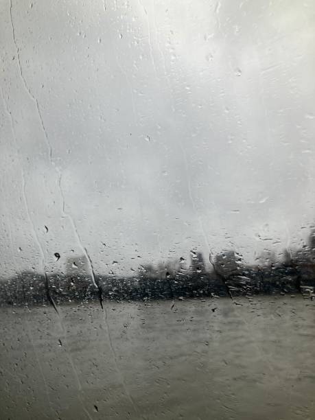 A blurred window during a rainy day in London. Depression mood. Sad day. Nostalgia day. Greys scale. London skyline blurred.