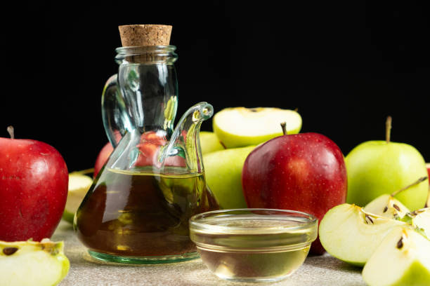 istock Apple cider vinegar in a glass vinegar bowl among apples 2194572246