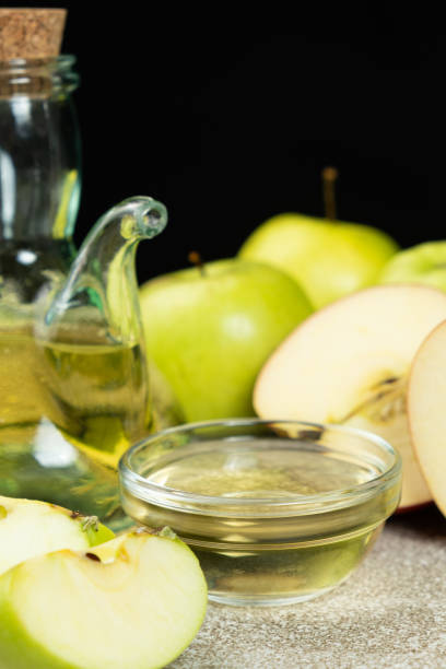 istock Apple cider vinegar in a glass vinegar bowl among apples 2194572290