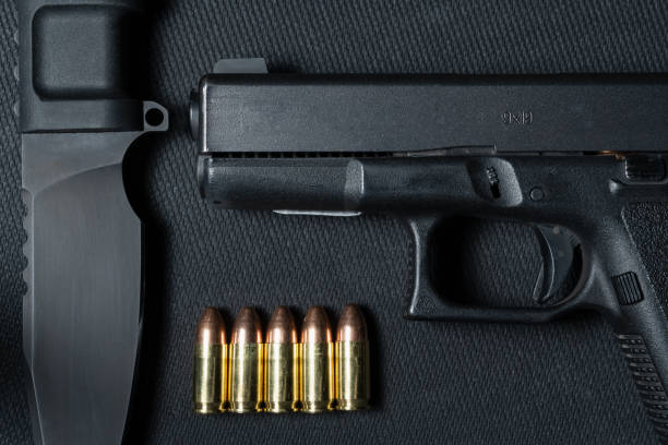 istock Pistol, 9mm ammo and a fixed blade tactical knife. 2194572669