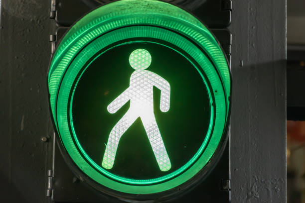 Green light of vintage traffic light close-up. Metallic old-fashioned startlight. Safety equipment is road signal of start traffic. Regulation safety with green lens. Warn retro style control.