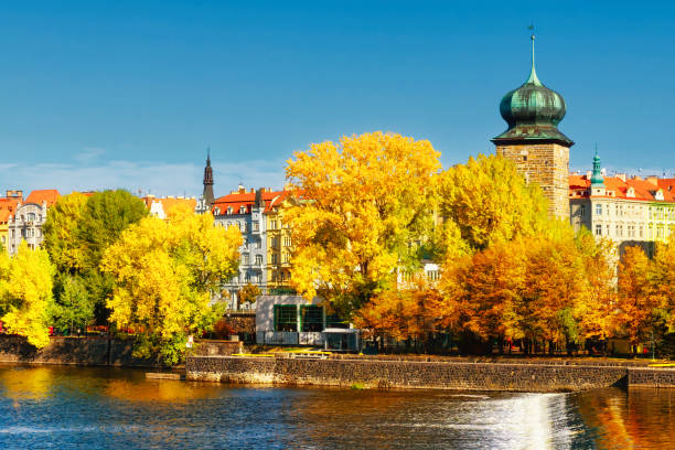 istock Ancient tower on the river bank in the fall. Autumn Prague. Landscape. 2194575264