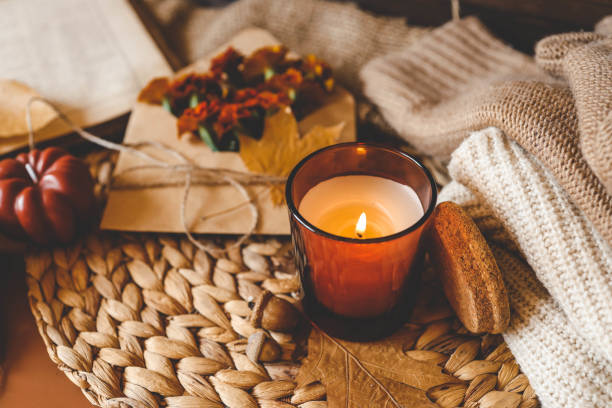 istock Burning candle in a cozy warm homey autumn atmosphere 2194578050