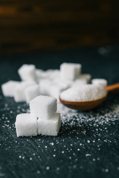 istock White crystalline sugar cubes on a wooden spoon 2194578548