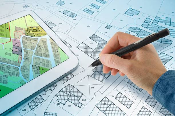 istock BUILDINGS PERMIT CONCEPT WITH IMAGINARY CADASTRAL MAP ON DIGITAL TABLET - Building activity and construction industry with General Urban Plan 2194579631