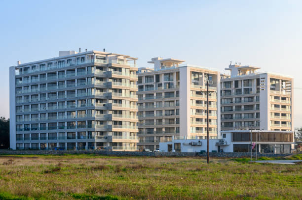 istock Modern residential buildings rise amidst lush greenery in a tranquil setting during golden hour 2194580159