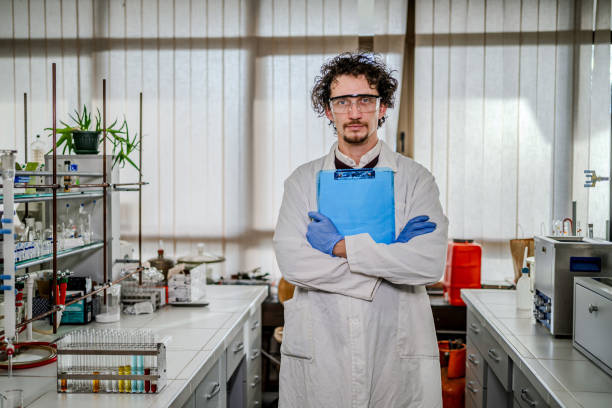 Male scientist looking at his phone in the lab.