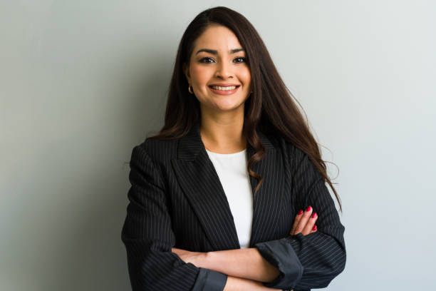 istock Confident hispanic businesswoman smiling with folded arms in office 2194590868