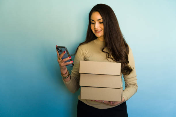 istock Online seller managing inventory and using smartphone app 2194592299