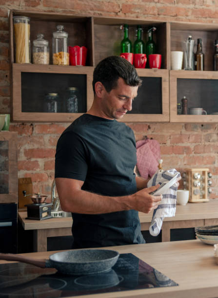 istock Attractive Athletic Drying Dishes After Washing 2194594066