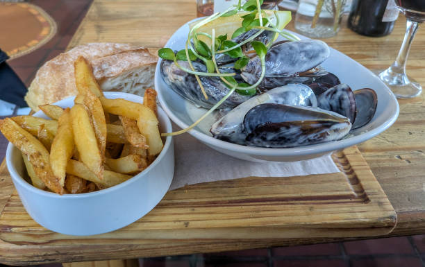 istock Fresh seafood dish with mussels, fries, and wine 2194594241