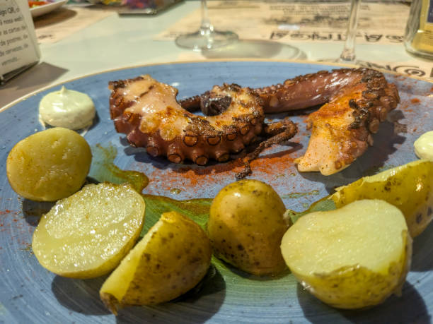 istock Grilled octopus served with roasted potatoes and sauce 2194594355