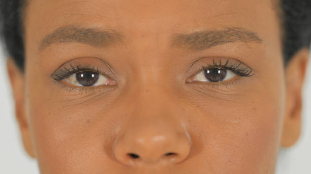 istock Close up of Female Blinking Eyes on White Background 2194597776