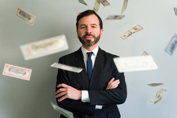 istock Confident businessman posing with falling money rain 2194597910
