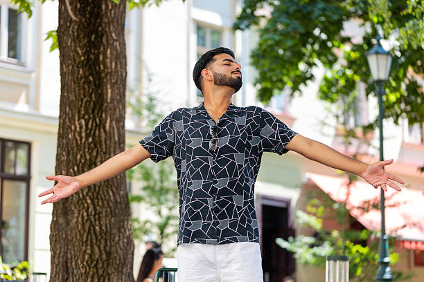 istock Indian man taking a deep breath of fresh air relaxing taking a break resting meditating calm down 2194602044