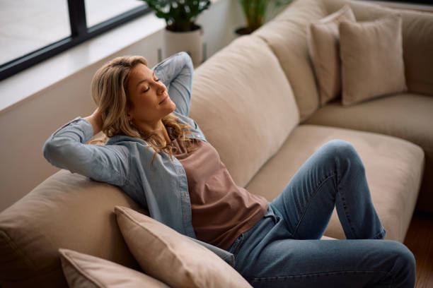 istock Relaxed woman enjoying on the sofa at home. 2194604460