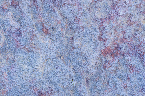 Background with ice-covered rock texture on a cold winter morning
