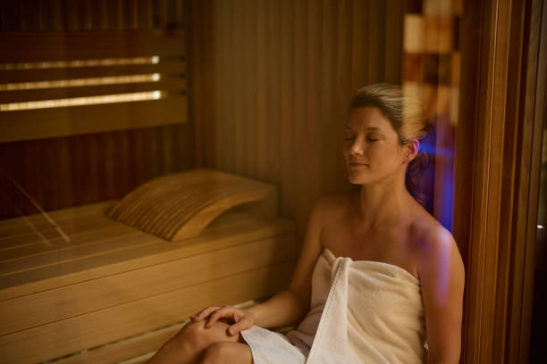 istock Relaxed woman sitting in sauna at the spa. 2194605443